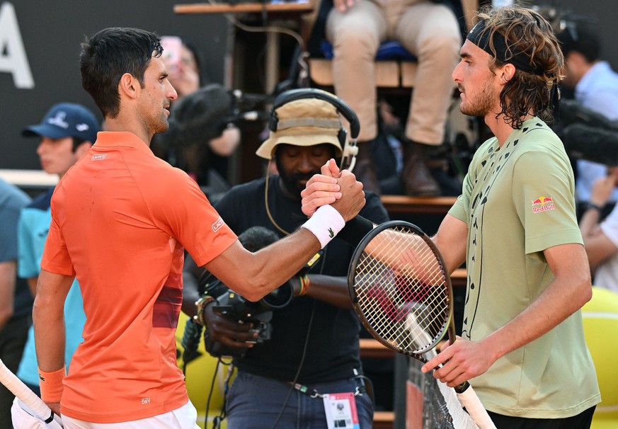 epa09949464 Novak Djokovic of Serbia (L) is congratulated by Stefanos Tsitsipas of Greece after winning their men&#039;s singles final match at the Italian Open tennis tournament in Rome, Italy, 15 Ma ...