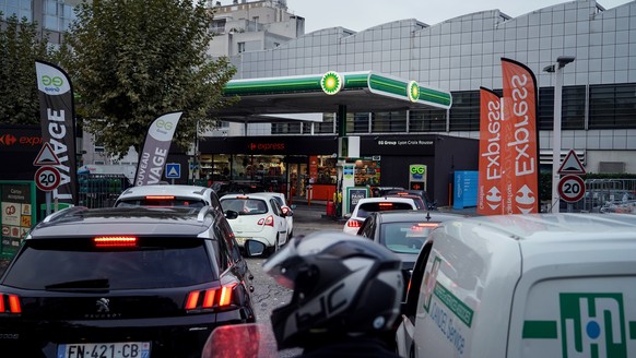 Drivers line up to buy gas in a station, in Lyon, central France, Tuesday, Oct. 11, 2022. Shortages which the government says are largely caused by strikes that have hit French fuel refineries are mak ...