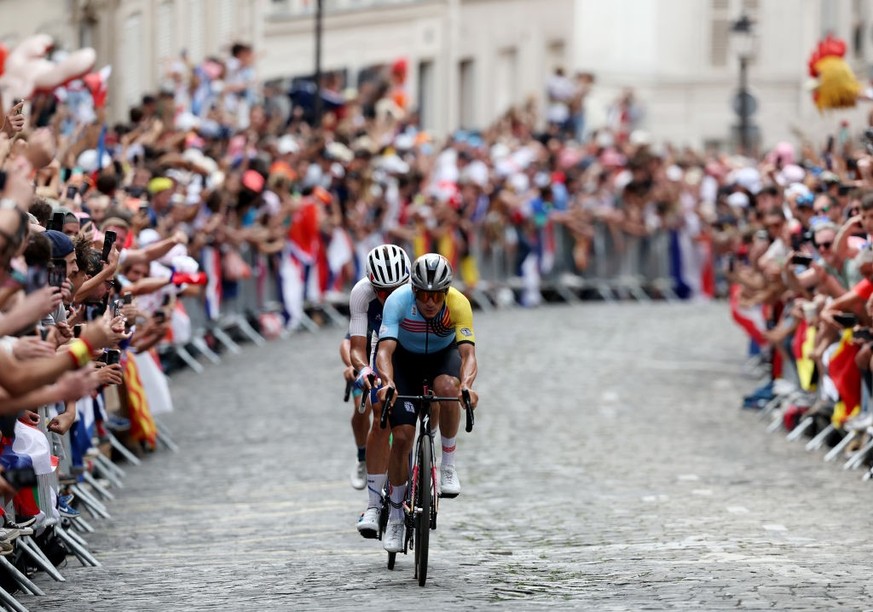 PARIS, FRANCE - AUGUST 03: Valentin Madouas of Team France and Remco Evenepoel of Team Belgium competes in the breakaway passing through the Cote de la butte Montmartre during the Men&#039;s Road Race ...