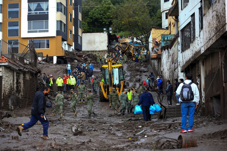 epa09721352 Soldiers help in the cleaning work on the mudslide caused by the rains of 31 January, which affected some neighborhoods in the west of the Ecuadorian capital and caused at least 18 fatalit ...