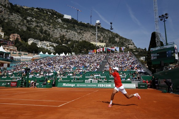 epa07513896 Novak Djokovic of Serbia returns the ball to Taylor Fritz of US during their third round match at the Monte-Carlo Rolex Masters tournament in Roquebrune Cap Martin, France, 18 April 2018.  ...