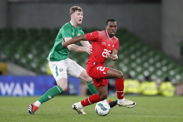 Ireland&#039;s Nathan Collins, left, challenges for the ball with Switzerland&#039;s Derek Kutesa during the international friendly soccer match between Ireland and Switzerland at the Aviva Stadium in ...