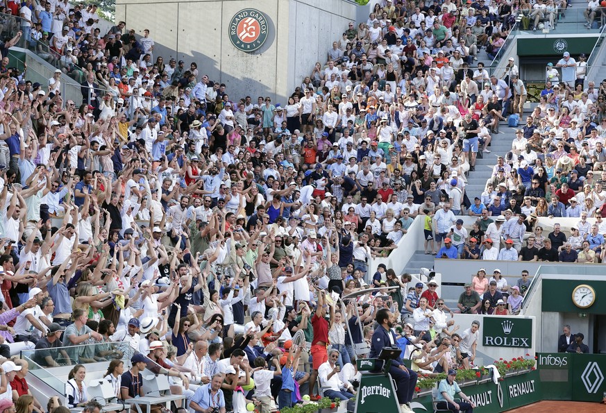 epa10674869 Spectators react on Court Suzanne Lenglen as Holger Rune of Denmark plays Francisco Cerundolo of Argentina in their Men&#039;s Singles fourth round match during the French Open Grand Slam  ...