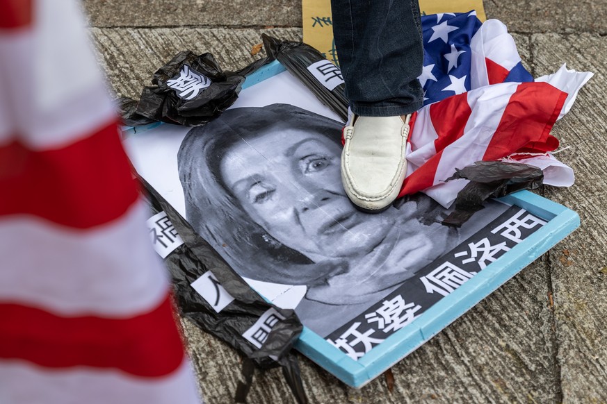 epaselect epa10103683 A group of pro-China supporters steps on a mock up funeral photo of US House Speaker Nancy Pelosi outside of the US Consulate General in Hong Kong and Macau, in Hong Kong, China, ...
