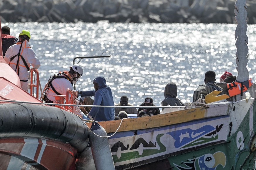 epa12234383 Migrants arrive in the port of La Restinga, after being located by Spain's Maritime Rescue south of El Hierro island, Spain's Canary Islands, 12 July 2025. A group of more than 5 ...