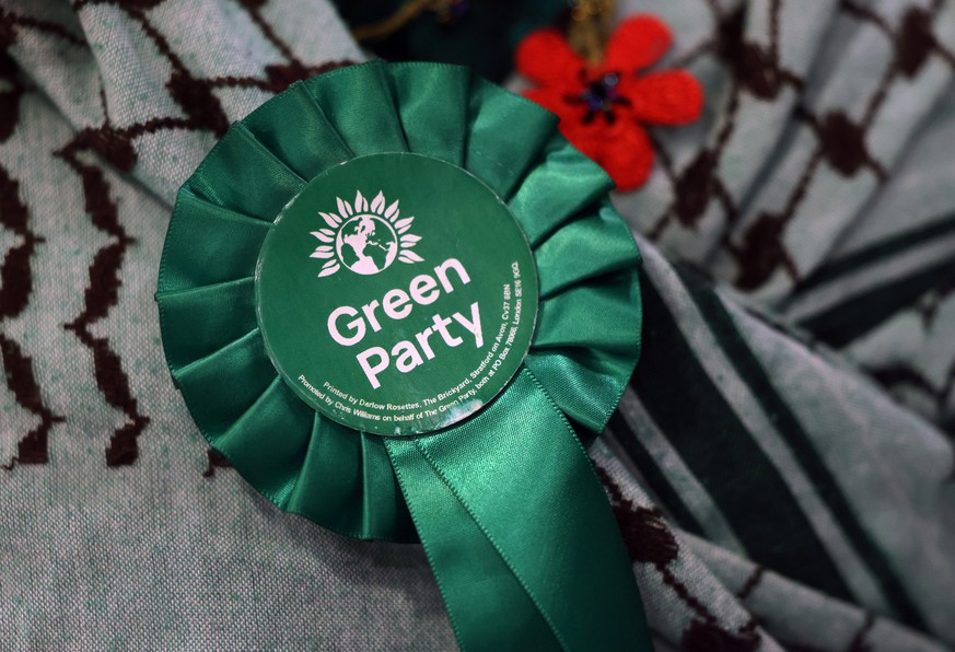 epa12943465 A Green Party rossette at a local election count in Lewisham in south London, Britain, 09 May 2026. Local elections took place across the United Kingdom on 07 May 2026. The ruling Labour P ...