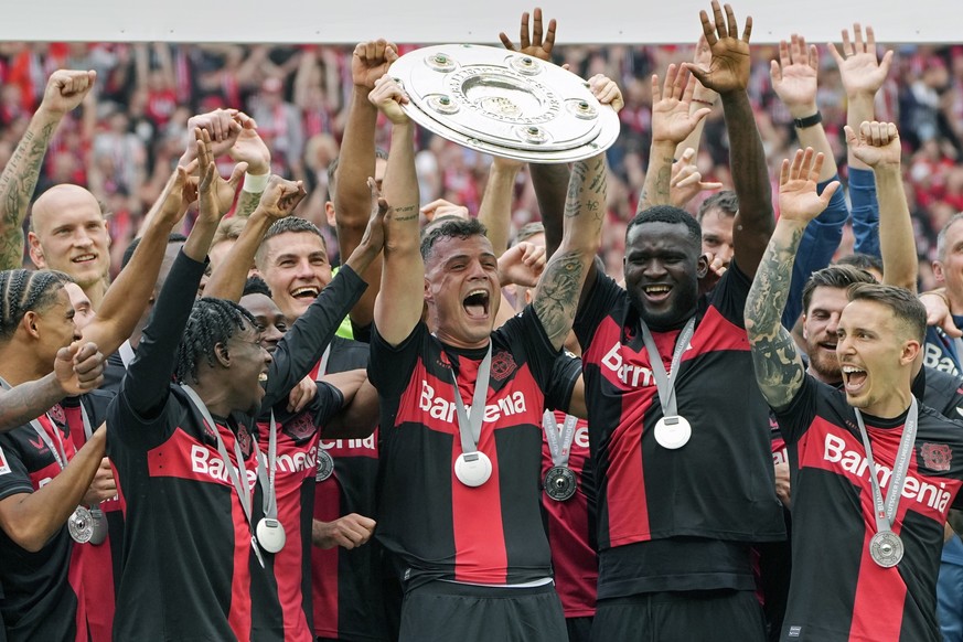 Leverkusen&#039;s Granit Xhaka celebrates with the trophy as his team won the German Bundesliga, after the German Bundesliga soccer match between Bayer Leverkusen and FC Augsburg at the BayArena in Le ...