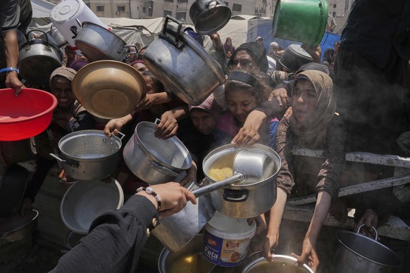 Palestinians struggle to get donated food at a community kitchen, in Gaza City, northern Gaza Strip, Saturday, July 26, 2025. (AP Photo/Abdel Kareem Hana)
Israel Palestinians Gaza