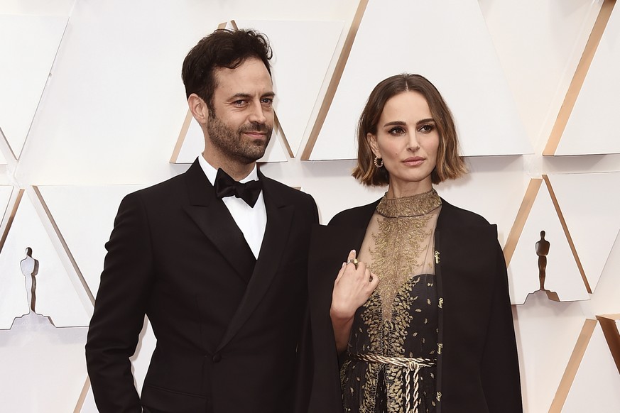 FILE - Benjamin Millepied, left, and Natalie Portman appear at the Oscars in Los Angeles on Feb. 9, 2020. Portman and Millepied have divorced after 11 years of marriage and two children. The Oscar-win ...