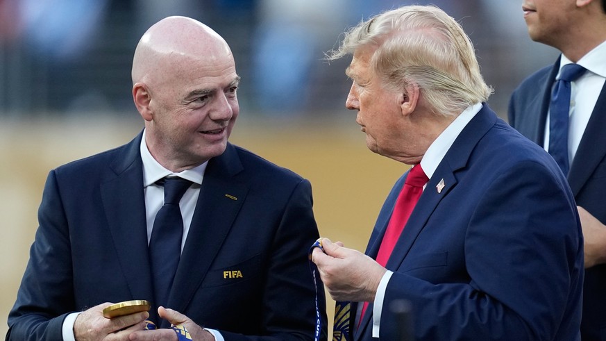 President Donald J. Trump speaks with FIFA President Gianni Infantino during the awards ceremony at the end of the World Cup final soccer match between Spain and Argentina in East Rutherford, N.J., ne ...