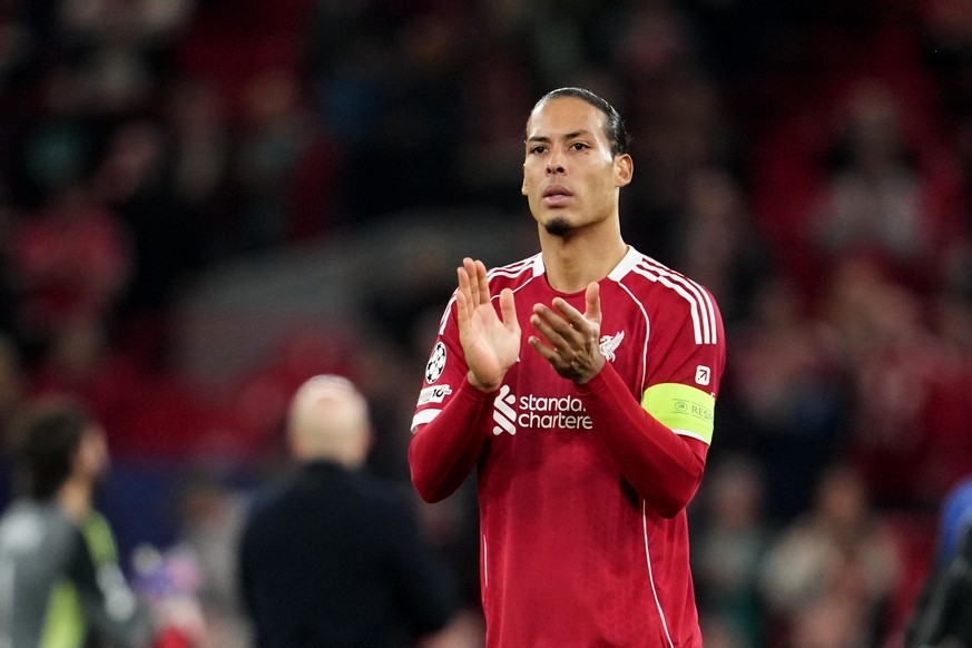 Liverpool's Virgil van Dijk applauds to supporters at the end of the second leg of the Champions League round of 16 soccer match between Liverpool and Galatasaray, in Liverpool, England, Wednesda ...