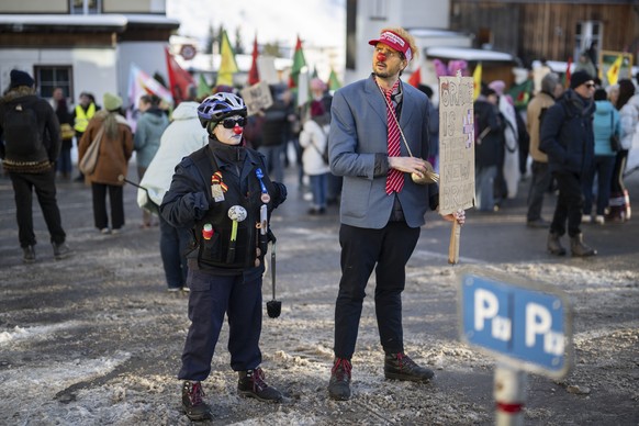 epaselect epa12658961 Protesters dressed up as US President Trump (R) and police pose during a demonstration prior the 56th annual meeting of the World Economic Forum, WEF, in Davos, Switzerland, 18 J ...