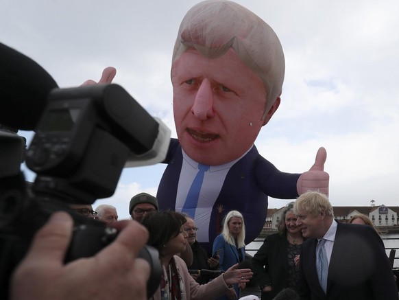 British Prime Minister Boris Johnson speaks to the media next to a large inflatable of him and flanked by Jill Mortimer, the winning Conservative Party candidate of the Hartlepool by-election, at Hart ...