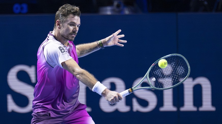 Switzerland's Stan Wawrinka returns a ball to Serbia's Miomir Kecmanovic during their first round match at the Swiss Indoors tennis tournament at the St. Jakobshalle in Basel, Switzerland, o ...
