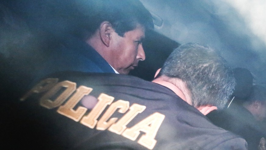 FILE - Peru&#039;s ousted President Pedro Castillo is escorted by police at the police station where he is being held in Lima, Peru, Wednesday, Dec. 7, 2022. Castillo was ousted by Congress and arrest ...