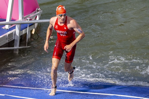 Adrien Briffod of Switzerland comes out of the water after the swimming during the men&#039;s triathlon competition at the 2024 Paris Summer Olympics in Paris, France, Wednesday, July 31, 2024. (KEYST ...