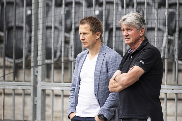 YB&#039;s sports director Christoph Spycher, left, and Gerard Castella, head of training, watch a training session ahead of Wednesday&#039;s UEFA Champions League Play-off first leg soccer match betwe ...
