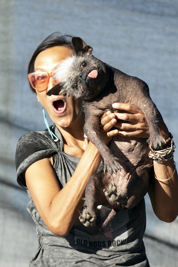 Jeneda Benally of Flagstaff, Ariz. poses for a photo with her dog Mr. Happy Face, the winner of the 2022 World&#039;s Ugliest Dog competition, Friday, June 24, 2022, in Petaluma, Calif. (AP Photo/D. R ...