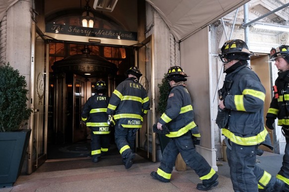 NEW YORK, NEW YORK - MARCH 15: Members of the FDNY work on putting out a fire in an apartment in the Sherry-Netherland luxury building that purportedly belongs to Guo Wengui on March 15, 2023 in New Y ...