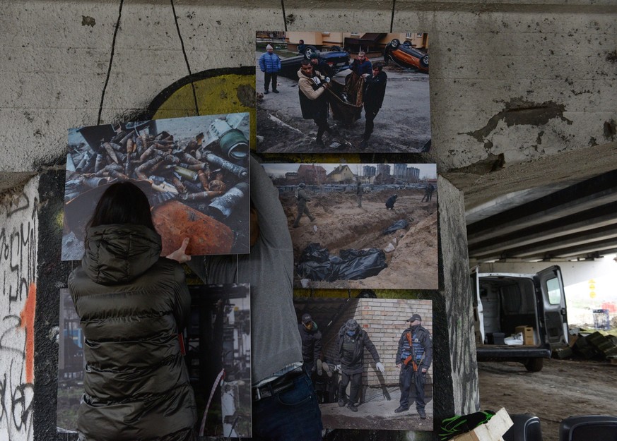 March 31, 2023, Irpin, Ukraine: People hang pictures at an exhibition dedicated to the liberation of Bucha. Ukraine marks the first anniversary of the beginning of the largest military attack in Europ ...