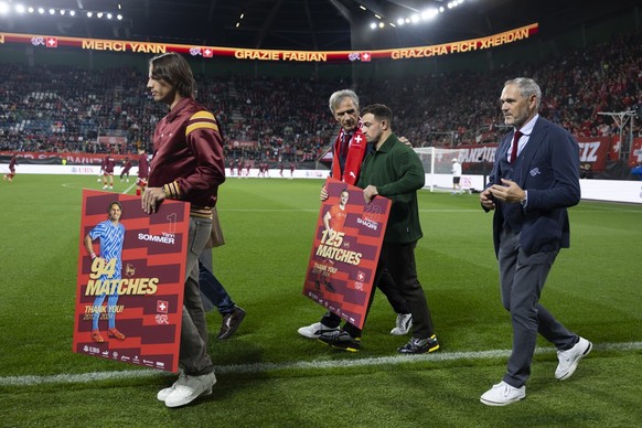 Former Switzerland&#039;s national team players Yann Sommer, left, Fabian Schaer, hidden, and Xherdan Shaqiri, center, are honoured for their lifetime achievement with the Swiss national team by Switz ...