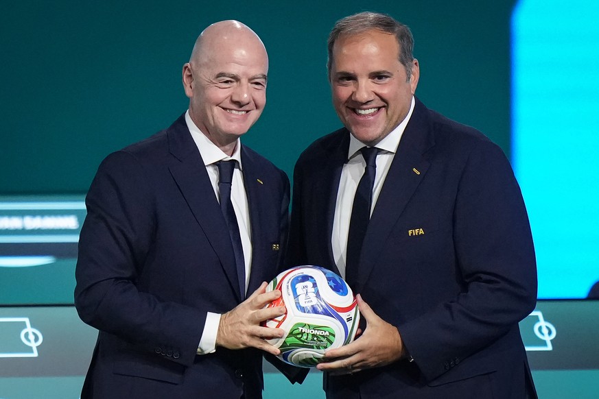 FIFA President Gianni Infantino, left, and FIFA Vice-President and CONCACAF President Victor Montagliani pose with a soccer ball during the 76th FIFA Congress in Vancouver, British Columbia, Thursday, ...