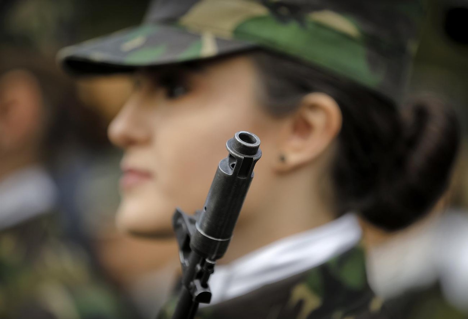 A student stands at attention before the swearing in ceremony for the military students, in Bucharest, Romania, Wednesday, Oct. 25, 2017. The Romanian Army is celebrating their Army Day and marking 10 ...