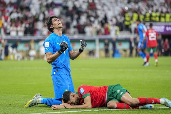 Morocco&#039;s goalkeeper Yassine Bounou, left, celebrates with his teammate Morocco&#039;s Achraf Hakimi their team victory over Portugal during the World Cup quarterfinal soccer match between Morocc ...