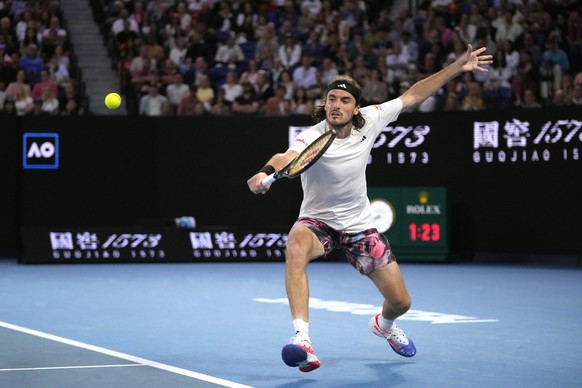 Stefanos Tsitsipas of Greece plays a backhand return to Jannik Sinner of Italy during their fourth round match at the Australian Open tennis championship in Melbourne, Australia, Sunday, Jan. 22, 2023 ...