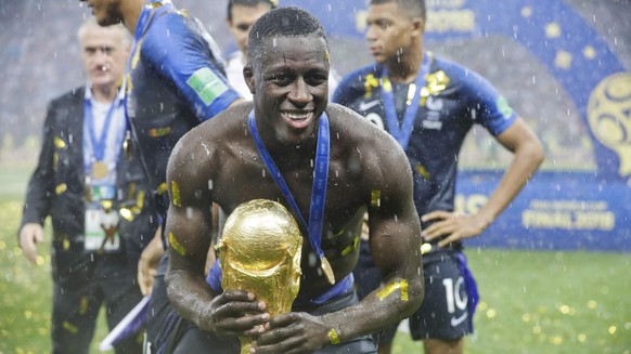 France's Benjamin Mendy holds the trophy at the end of the final match between France and Croatia at the 2018 soccer World Cup in the Luzhniki Stadium in Moscow, Russia, Sunday, July 15, 2018. (AP Pho ...