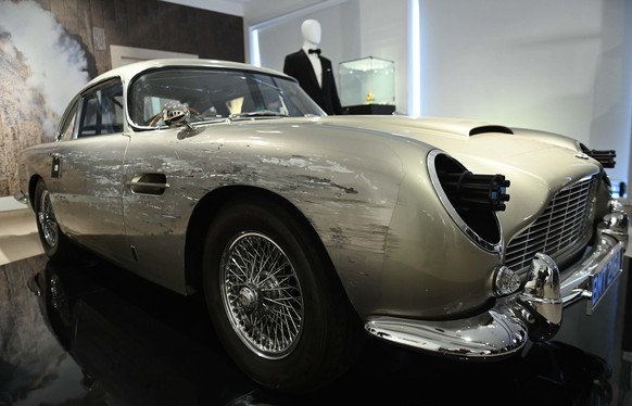 epa10207041 An Aston Martin DB5 stunt car from the film &#039;No Time To Die&#039; is displayed during a media preview of 60 years of James Bond at Christies Auction House in London, Britain 26 Septem ...