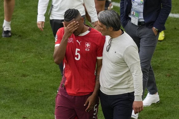 Switzerland&#039;s head coach Murat Yakin comforts Switzerland&#039;s Manuel Akanji after a quarterfinal match between England and Switzerland at the Euro 2024 soccer tournament in Duesseldorf, German ...