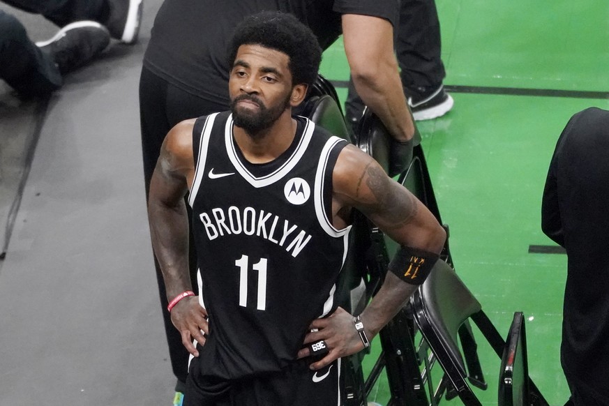 FILE - Brooklyn Nets guard Kyrie Irving looks up at the fans at TD Garden after they defeated the Boston Celtics in Game 4 during an NBA basketball first-round playoff series in Boston, in this Sunday ...