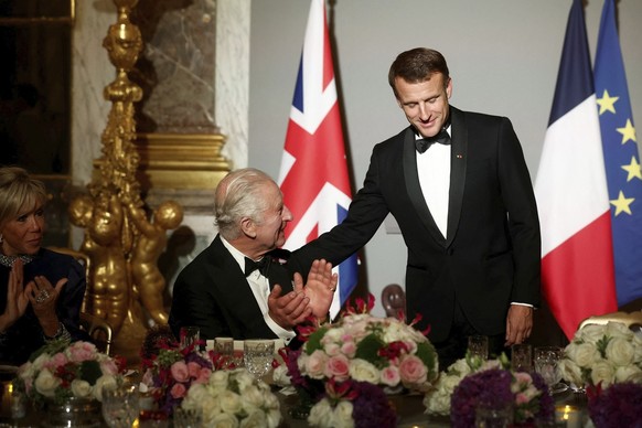 epa10872898 French President Emmanuel Macron (R) and Britain's King Charles III attend a state dinner in the Hall of Mirrors at the Palace of Versailles, in Versailles, near Paris, France, 20 Sep ...