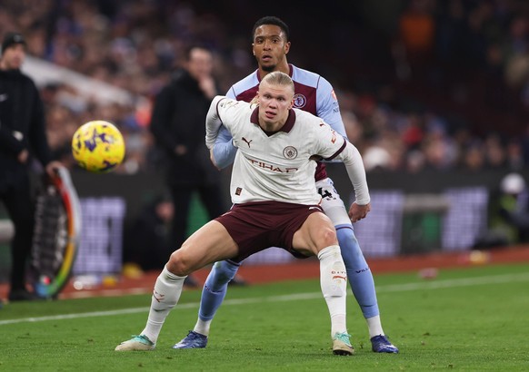 Birmingham, England, 6th December 2023. Erling Haland of Manchester City is challenged by Ezri Konsa of Aston Villa during the Premier League match at Villa Park, Birmingham. Picture credit should rea ...