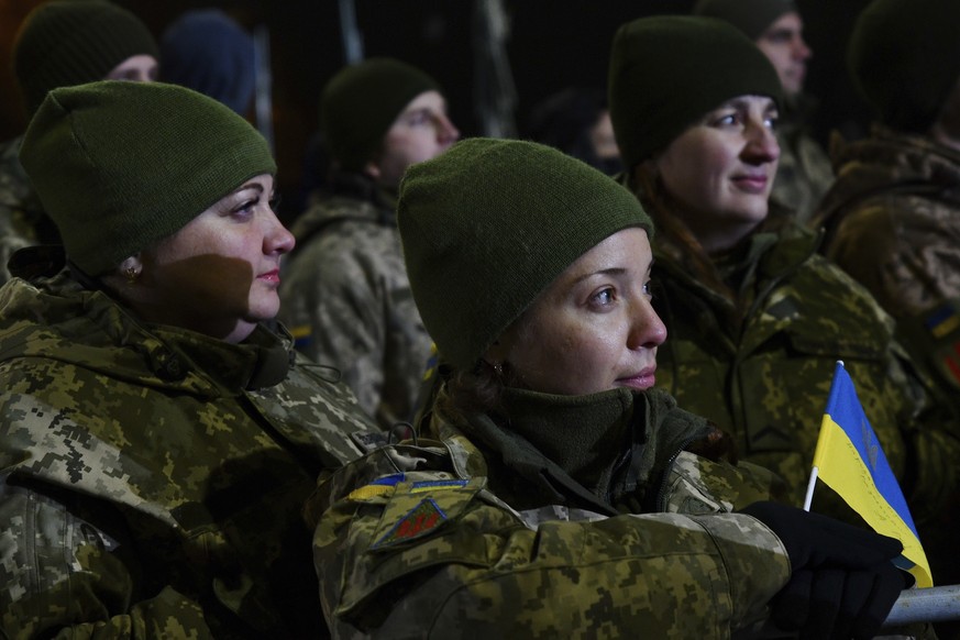 Ukrainian soldiers watch at the big screen as Ukrainian President Volodymyr Zelenskyy addresses during the parade marking the Day of the Armed Forces of Ukraine in the center of Kramatorsk, Ukraine, M ...