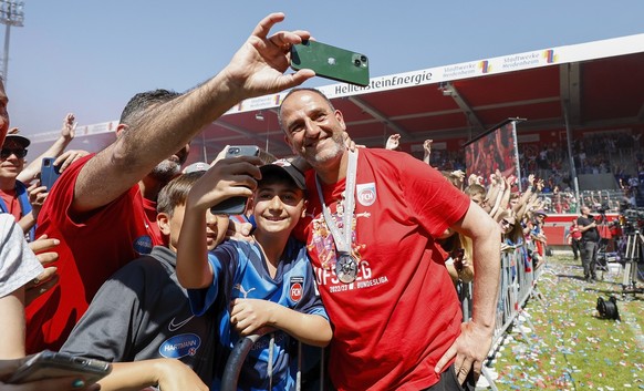 29.05.2023, Baden-W�rttemberg, Heidenheim: Fu�ball: Aufstiegsfeier, 1. FC Heidenheim, Voith-Arena. Heidenheims Trainer Frank Schmidt (r) posiert bei der Feier zum erstmaligen Aufstieg in die Fu�ball-B ...