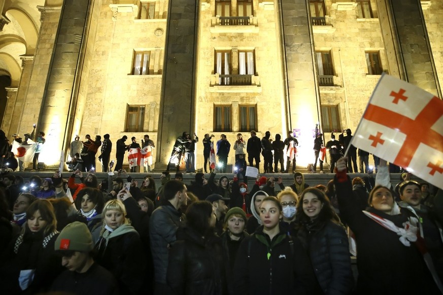 Protesters gather during a rally against a draft law aimed at curbing the influence of &quot;foreign agents&quot; near the Georgian parliament building in Tbilisi, Georgia, Thursday, March 9, 2023. Fo ...