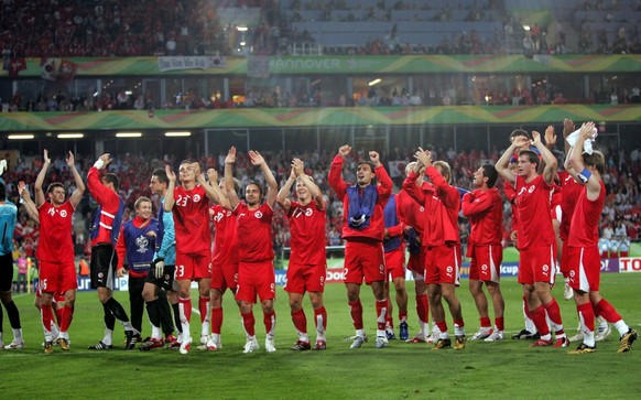 Swiss players celebrate their 2-0 win at the end of the World Cup, Group G soccer match between Switzerland and South Korea, at the Hanover stadium, Germany, Friday, June 23, 2006. The other teams in  ...