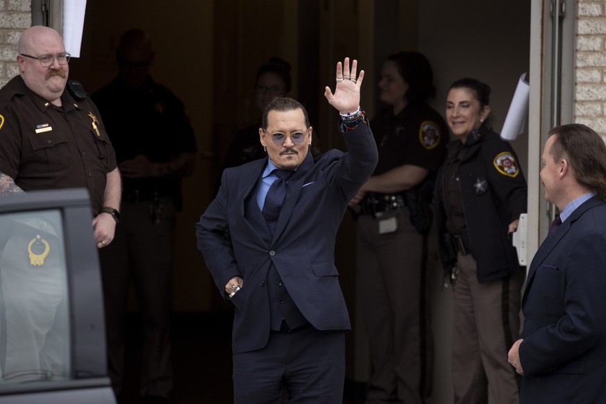 epa09981039 US actor Johnny Depp reacts as he leaves after closing arguments in the 50 million US dollar Depp vs Heard defamation trial at the Fairfax County Circuit Court in Fairfax, Virginia, USA, 2 ...