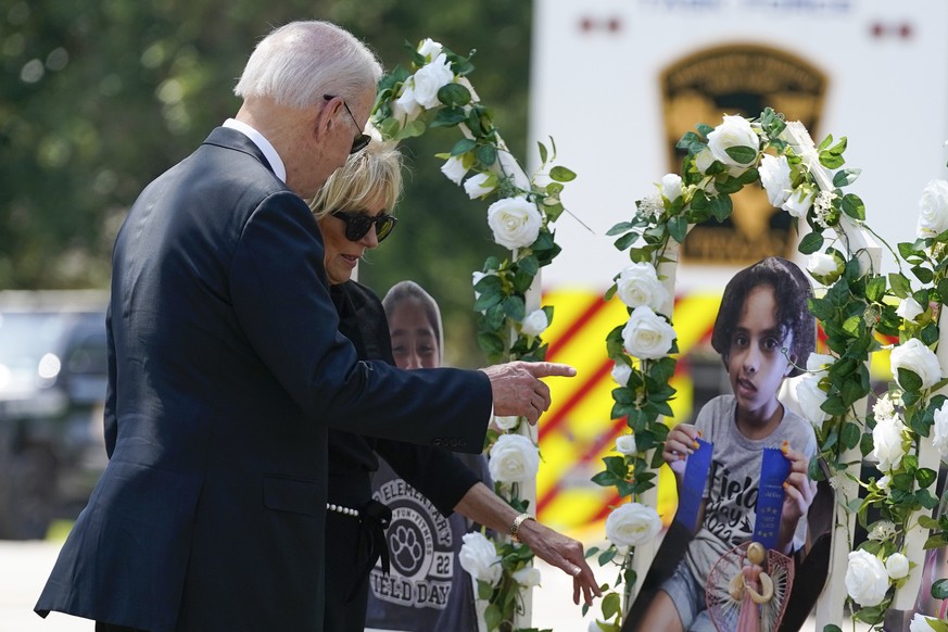 President Joe Biden and first lady Jill Biden visit a memorial at Robb Elementary School to pay their respects to the victims of the mass shooting, Sunday, May 29, 2022, in Uvalde, Texas. (AP Photo/Ev ...