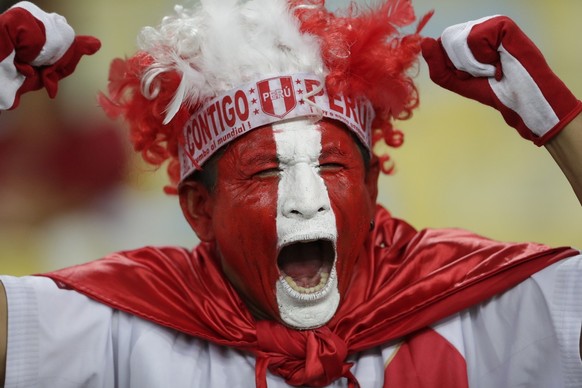 A Peru fans cheers for his team prior a Copa America Group A soccer match against Bolivia at Maracana stadium in Rio de Janeiro, Brazil, Tuesday, June 18, 2019. (AP Photo/Silvia Izquierdo)