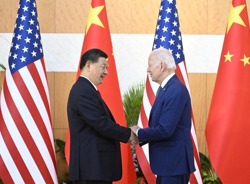 epa10305492 Chinese President Xi Jinping (L) greets his US counterpart Joe Biden before their meeting, one day ahead of the G20 Summit in Bali, Indonesia, 14 November 2022. The 17th Group of Twenty (G ...