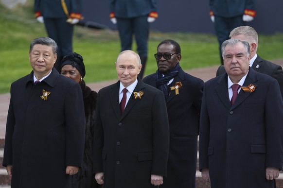 epa12085627 President of Russia Vladimir Putin (C), President of China Xi Jinping (L), President of Tajikistan Emomali Rahmon (R) and other foreign leaders take part in a wreath laying ceremony at the ...