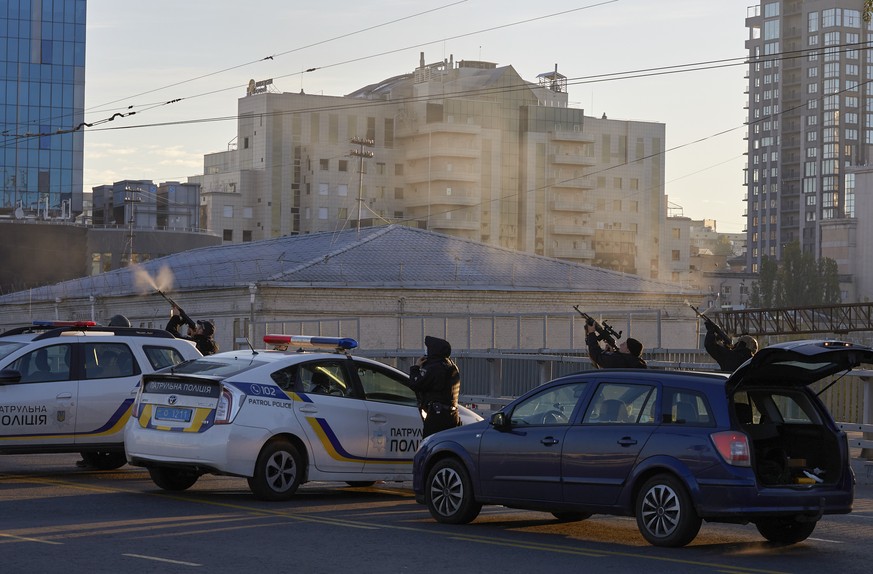 Ukrainian soldiers shoot a drone that appears in the sky seconds before it fired on buildings in Kyiv, Ukraine, Monday, Oct. 17, 2022. (AP Photo/Vadym Sarakhan)