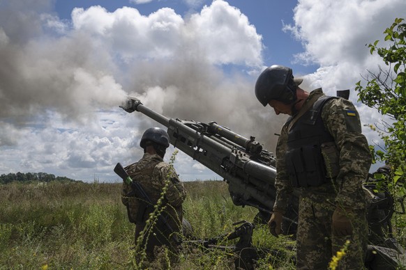Ukrainian servicemen fire at Russian positions from a U.S.- supplied M777 howitzer in Kharkiv region, Ukraine, on Thursday, July 14, 2022. (AP Photo/Evgeniy Maloletka)