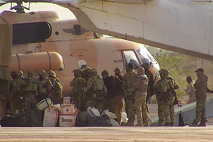 This undated photograph handed out by French military shows Russian mercenaries boarding a helicopter in northern Mali. Russia has engaged in under-the-radar military operations in at least half a doz ...
