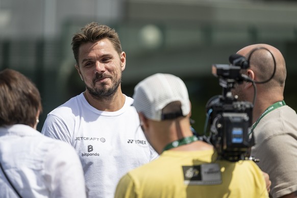 Swiss player Stanislas Stan Wawrinka, second left, gives a TV Interview between practice sessions ahead of the All England Lawn Tennis Championships in Wimbledon, London, Saturday, June 29, 2024. The  ...