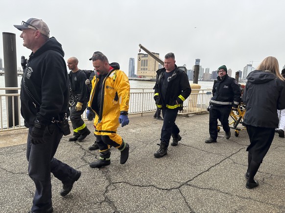 First responders walk along Pier 40, Thursday, April 10, 2025, in New York, across from where a helicopter went down in the Hudson River in Jersey City, N.J. (AP Photo/Jennifer Peltz)
NYC Helicopter C ...