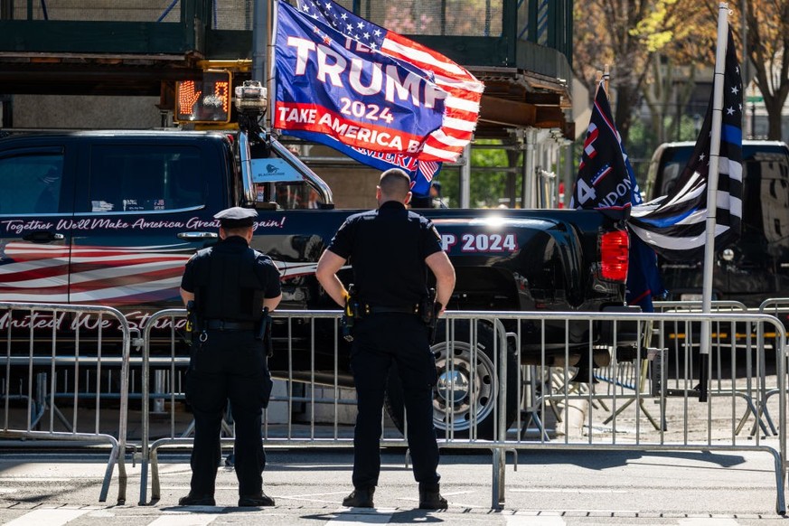 NEW YORK, NEW YORK - APRIL 15: As police watch, supporters of Donald Trump gather outside of Manhattan Criminal Courthouse for the start of the first-ever criminal trial against a former president of  ...